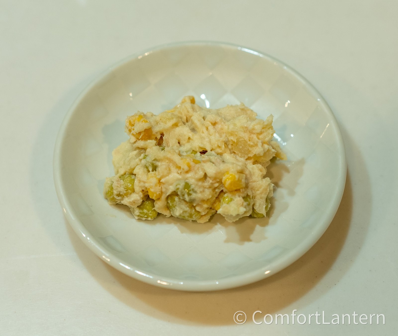 小鉢に取り分けたツナと枝豆の和風ポテトサラダ。じゃがいもに枝豆とコーンが混ざっている