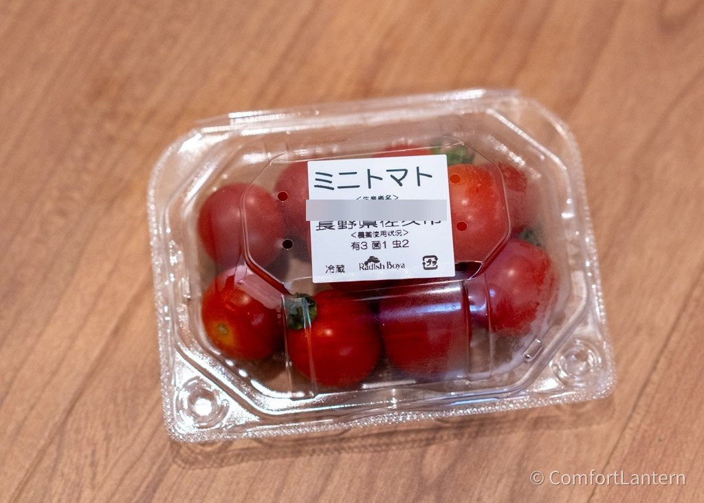 透明パックに入ったミニトマト。ラベルに品名と産地、農薬使用状況が印刷されている
